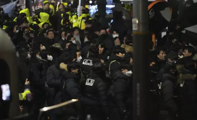 FILE - Police officers try to enter as the members of the ruling People Power Party try to block them in front of the gate of the presidential residence in Seoul, South Korea, on Jan. 15, 2025. (AP Photo/Lee Jin-man, File)