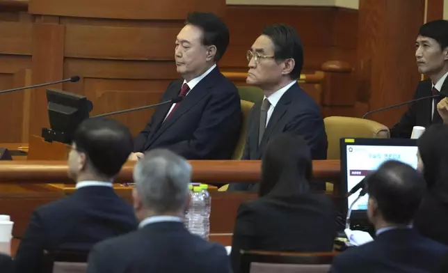 FILE - South Korea's impeached President Yoon Suk Yeol, top left, attends a hearing of his impeachment trial at the Constitutional Court in Seoul, South Korea, on Feb. 11, 2025. (AP Photo/Lee Jin-man, Pool, File)