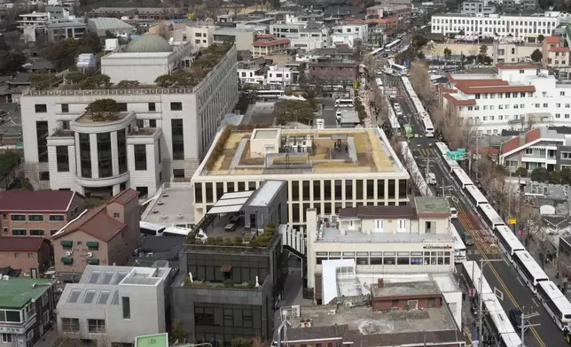 FILE - Police buses are parked to make walls on the road as part of preparations for an eventuality near the Constitutional Court, top left, in Seoul, South Korea, on Feb. 25, 2025. (AP Photo/Ahn Young-joon, File)