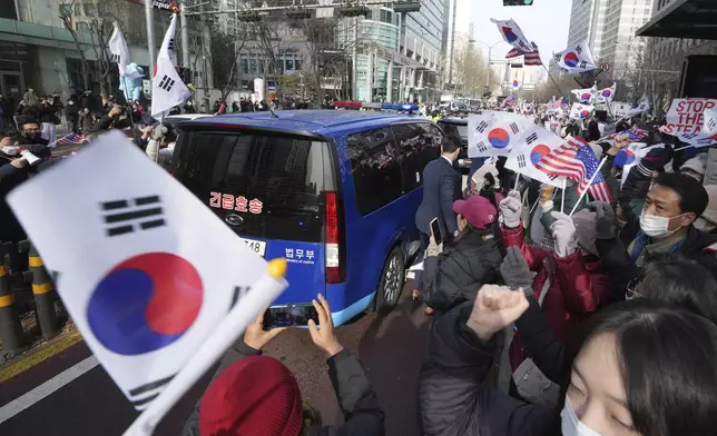 FILE - Supporters for impeached South Korean President Yoon Suk Yeol greet as his motorcade passes by near the Seoul Western District Court in Seoul, South Korea, on Jan. 18, 2025. (AP Photo/Lee Jin-man, File)