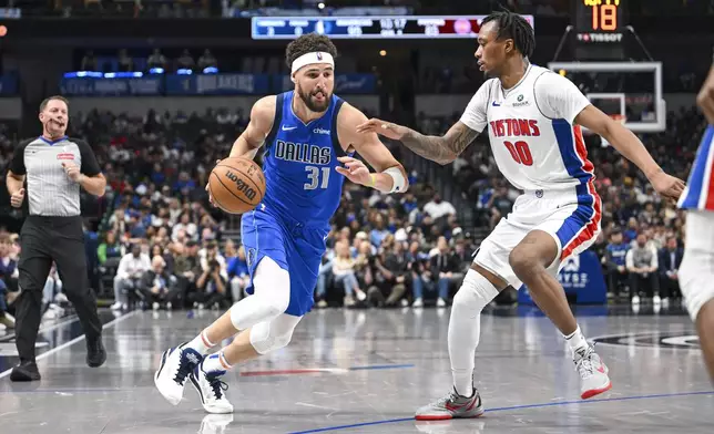 Dallas Mavericks guard Klay Thompson (31) drives against Detroit Pistons forward Ronald Holland II, right, during the second half of an NBA basketball game, Friday, March 21, 2025, in Dallas, Texas. (AP Photo/Albert Pena)