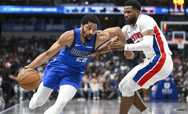 Dallas Mavericks guard Spencer Dinwiddie drives against Detroit Pistons guard Malik Beasley during the second half of an NBA basketball game, Friday, March 21, 2025, in Dallas, Texas. (AP Photo/Albert Pena)
