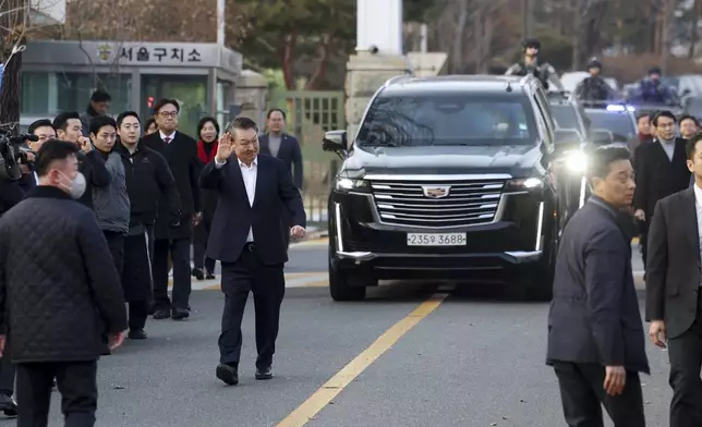 Impeached South Korean President Yoon Suk Yeol greets to his supporters after he came out of a detention center in Uiwang, South Korea, Saturday, March 8, 2025. (Hong Hyo-shik/Newsis via AP)