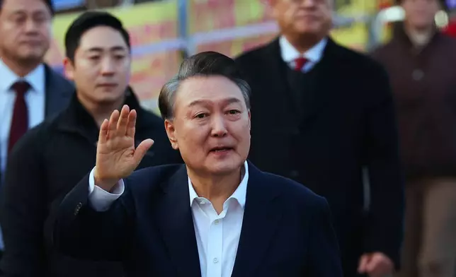 Impeached South Korean President Yoon Suk Yeol waves to his supporters as he comes out of a detention center in Uiwang, South Korea, Saturday, March 8, 2025. (Kim Do-hun/Yonhap via AP)