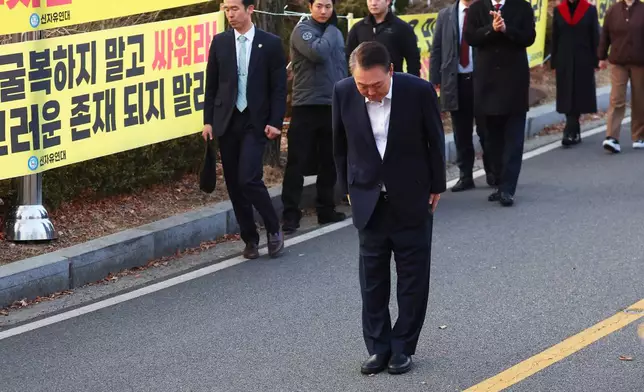 Impeached South Korean President Yoon Suk Yeol greets to his supporters after he came out of a detention center in Uiwang, South Korea, Saturday, March 8, 2025. (Kim Do-hun/Yonhap via AP)
