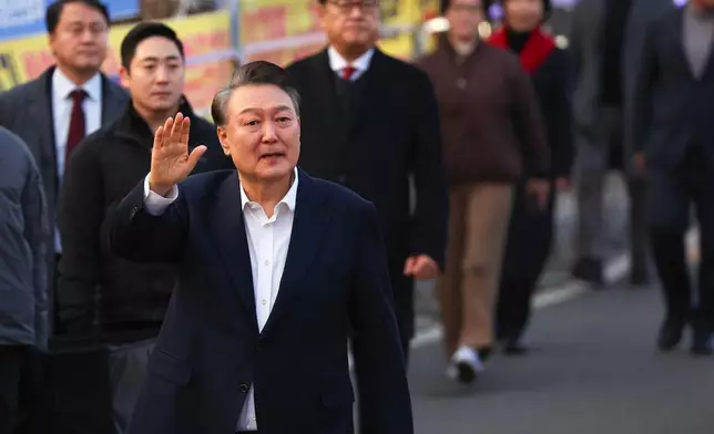 Impeached South Korean President Yoon Suk Yeol greets to his supporters after he came out of a detention center in Uiwang, South Korea, Saturday, March 8, 2025. (Kim Do-hun/Yonhap via AP)