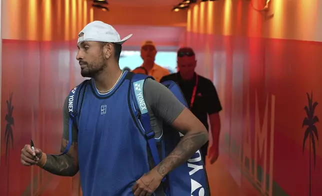 Nick Kyrgios, of Australia, walks from the court to sign autographs after defeating Mackenzie McDonald during the Miami Open tennis tournament, Wednesday, March 19, 2025, in Miami Gardens, Fla. (AP Photo/Lynne Sladky)
