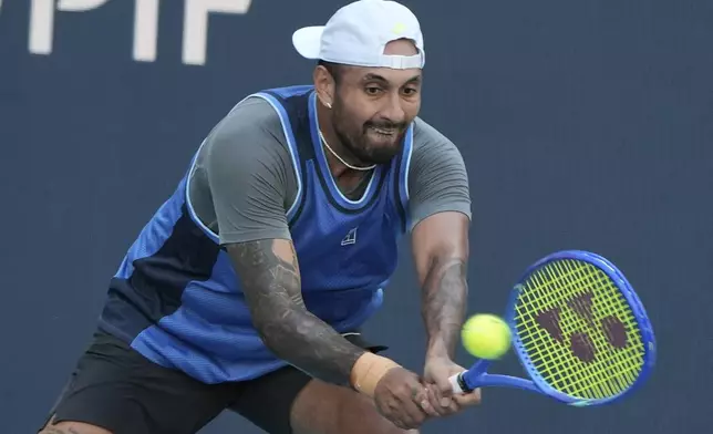 Nick Kyrgios, of Australia, hits a return to Mackenzie McDonald during the Miami Open tennis tournament, Wednesday, March 19, 2025, in Miami Gardens, Fla. (AP Photo/Lynne Sladky)
