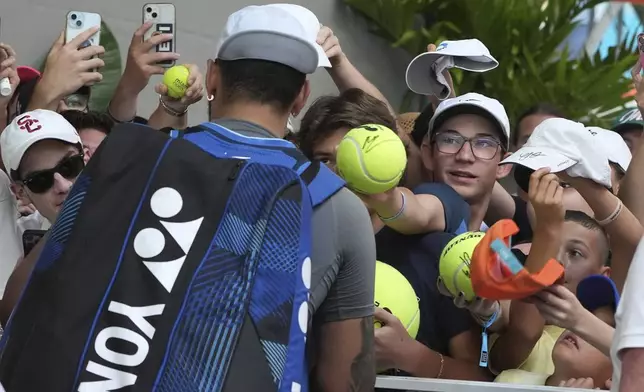 Nick Kyrgios, of Australia, signs autographs after defeating Mackenzie McDonald during the Miami Open tennis tournament, Wednesday, March 19, 2025, in Miami Gardens, Fla. (AP Photo/Lynne Sladky)