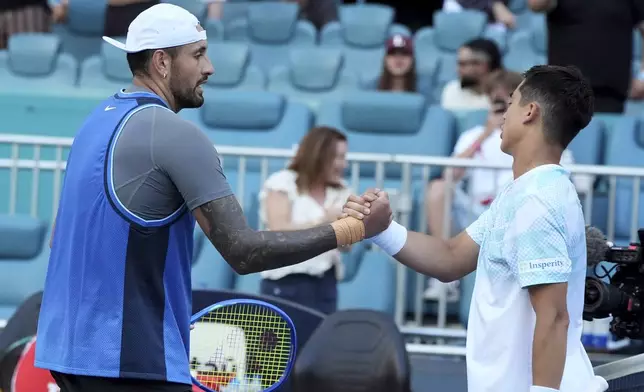 Nick Kyrgios, of Australia, left, shakes hands with Mackenzie McDonald, right, after winning their match during the Miami Open tennis tournament, Wednesday, March 19, 2025, in Miami Gardens, Fla. (AP Photo/Lynne Sladky)