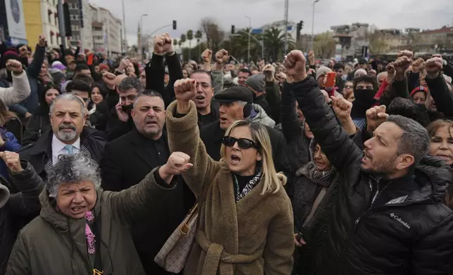People chant slogans as they protest outside the Vatan Security Department, where Istanbul Mayor Ekrem Imamoglu is expected to be taken following his arrest in Istanbul, Turkey, Wednesday, March 19, 2025. (AP Photo/Francisco Seco)