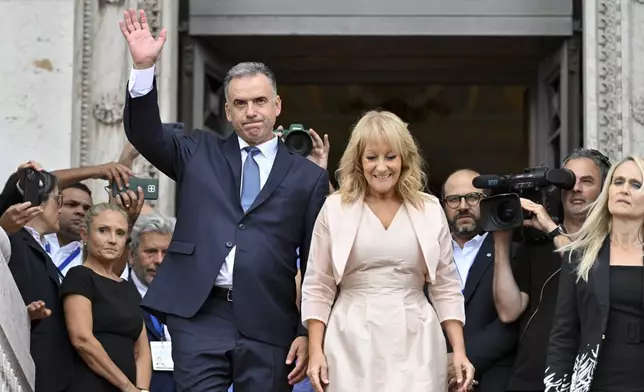 Uruguay's incoming President Yamandu Orsi and Vice President Carolina Cosse exit the Congress building after they attended their swearing ceremony, on Inauguration Day in Montevideo, Uruguay, Saturday, March 1, 2025. (AP Photo/Santiago Mazzarovich)