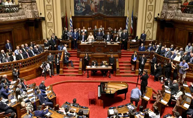Uruguay's newly sworn-in President Yamandu Orsi, center back at podium, addresses Congress on Inauguration Day, in Montevideo, Uruguay, Saturday, March 1, 2025. (AP Photo/Santiago Mazzarovich)