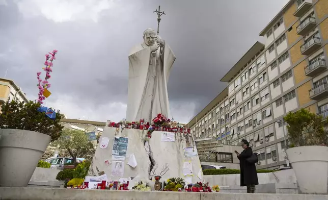 People pray for Pope Francis in front of the Agostino Gemelli Polyclinic, in Rome, Thursday, March 13, 2025, where he is hospitalized since Friday, Feb. 14. (AP Photo/Andrew Medichini)