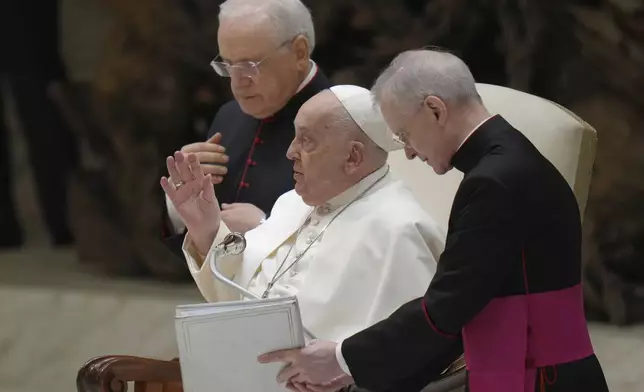 Pope Francis blesses the faithful during his weekly general audience in the Paul VI Hall, at The Vatican, Wednesday, Feb. 12, 2025. (AP Photo/Alessandra Tarantino)