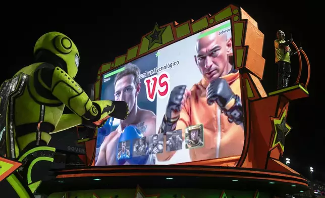 A performer from the Mocidade samba school directs a float alongside artificial intelligence images of Meta CEO Mark Zuckerberg, left, and Amazon CEO Jeff Bezos during Carnival celebrations at the Sambadrome in Rio de Janeiro, Tuesday, March 4, 2025. (AP Photo/Bruna Prado)