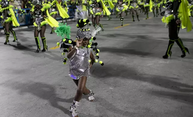 A performer from the Mocidade samba school dances during Carnival celebrations at the Sambadrome in Rio de Janeiro, Tuesday, March 4, 2025. (AP Photo/Bruna Prado)