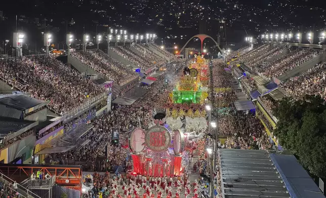 Performers from the Unidos de Padre Miguel samba school dance during Carnival celebrations at the Sambadrome in Rio de Janeiro, Sunday, March 2, 2025. (AP Photo/Silvia Izquierdo)