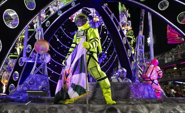 Performers from the Mocidade samba school look out from a float during Carnival celebrations at the Sambadrome in Rio de Janeiro, Tuesday, March 4, 2025. (AP Photo/Bruna Prado)