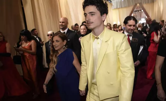 Nicole Flender, left, and Timothée Chalamet arrive at the Oscars on Sunday, March 2, 2025, at the Dolby Theatre in Los Angeles. (AP Photo/John Locher)