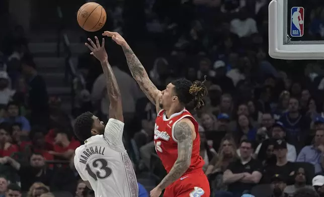 Memphis Grizzlies forward Brandon Clarke (15) blocks a shot against Dallas Mavericks forward Naji Marshall (13) during the first half of an NBA basketball game in Dallas, Friday, March 7, 2025. (AP Photo/LM Otero)