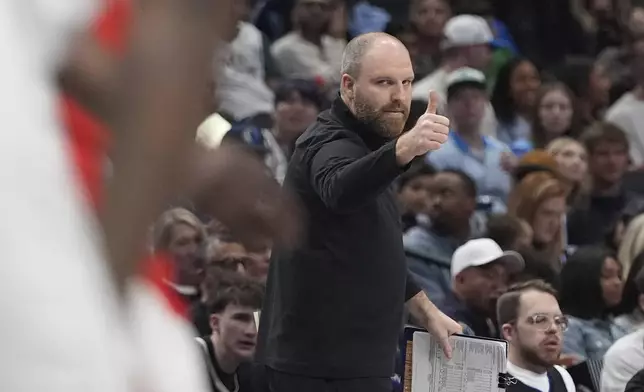 Memphis Grizzlies head coach Taylor Jenkins gestures from a sideline during the first half of an NBA basketball game against the Dallas Mavericks in Dallas, Friday, March 7, 2025. (AP Photo/LM Otero)