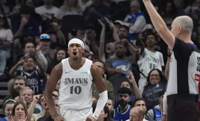 Dallas Mavericks guard Brandon Williams (10) reacts to scoring during the first half of an NBA basketball game against the Memphis Grizzlies in Dallas, Friday, March 7, 2025. (AP Photo/LM Otero)