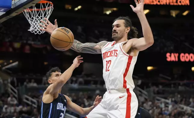 Houston Rockets center Steven Adams (12) loses control of the ball as he goes up for a shot against Orlando Magic forward Tristan da Silva, left, during the second half of an NBA basketball game, Wednesday, March 19, 2025, in Orlando, Fla. (AP Photo/John Raoux)