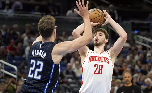 Houston Rockets center Alperen Sengun (28) shoots over Orlando Magic forward Franz Wagner (22) during the second half of an NBA basketball game, Wednesday, March 19, 2025, in Orlando, Fla. (AP Photo/John Raoux)