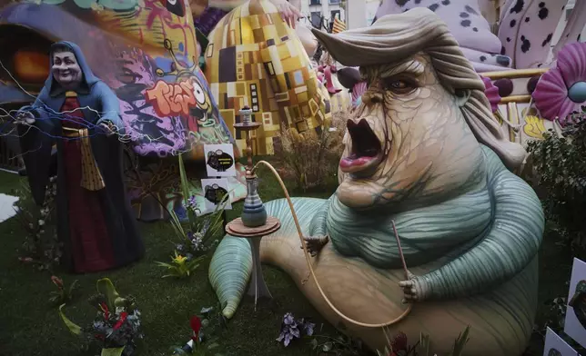 A cardboard sculpture known as "Ninot" depicting U.S. President Donald Trump is displayed during the Fallas festival in Valencia, Spain, on Wednesday, March 19, 2025. Five months after deadly floods ravaged Valencia, the Spanish city will host its biggest celebration of the year: Las Fallas. Sculptures were built using wreckage from peoples' homes and lampoon politicians accused of mishandling the catastrophe. (AP Photo/Alberto Saiz)