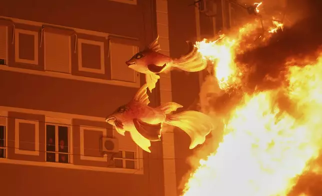 Cardboard sculptures known as "Ninots" burn during the Fallas festival in Valencia, Spain, on Wednesday, March 19, 2025. Five months after deadly floods ravaged Valencia, the Spanish city is hosting its biggest celebration of the year: Las Fallas. Sculptures were built using wreckage from peoples' homes and lampoon politicians accused of mishandling the catastrophe. (AP Photo/Alberto Saiz)