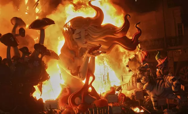 Cardboard sculptures known as "Ninots" burn during the Fallas festival in Valencia, Spain, on Wednesday, March 19, 2025. Five months after deadly floods ravaged Valencia, the Spanish city is hosting its biggest celebration of the year: Las Fallas. Sculptures were built using wreckage from peoples' homes and lampoon politicians accused of mishandling the catastrophe. (AP Photo/Alberto Saiz)