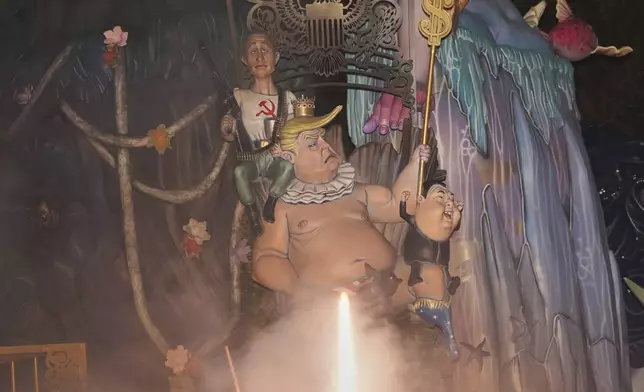 Cardboard sculptures known as "Ninots" depicting U.S. President Donald Trump, Russian president Vladimir Putin and North Korean leader Kim Jong Un begin to burn during the Fallas festival in Valencia, Spain, on Wednesday, March 19, 2025. Five months after deadly floods ravaged Valencia, the Spanish city is hosting its biggest celebration of the year: Las Fallas. Sculptures were built using wreckage from peoples' homes and lampoon politicians accused of mishandling the catastrophe. (AP Photo/Alberto Saiz)