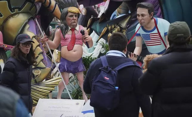 Cardboard sculptures known as "Ninots" depicting U.S. President Donald Trump and Elon Musk, right, are displayed during the Fallas festival in Valencia, Spain, on Wednesday, March 19, 2025. Five months after deadly floods ravaged Valencia, the Spanish city will host its biggest celebration of the year: Las Fallas. Sculptures were built using wreckage from peoples' homes and lampoon politicians accused of mishandling the catastrophe. (AP Photo/Alberto Saiz)