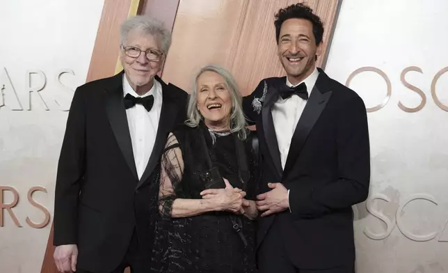 Elliot Brody, from left, Sylvia Plachy, and Adrien Brody arrive at the Oscars on Sunday, March 2, 2025, at the Dolby Theatre in Los Angeles. (Photo by Jordan Strauss/Invision/AP)