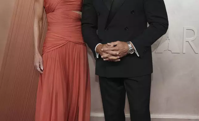 Kelly Ripa, left, and Mark Consuelos arrive at the Oscars on Sunday, March 2, 2025, at the Dolby Theatre in Los Angeles. (Photo by Jordan Strauss/Invision/AP)