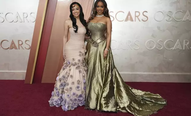 Kristy Sarah Scott, left, and H.E.R arrive at the Oscars on Sunday, March 2, 2025, at the Dolby Theatre in Los Angeles. (Photo by Jordan Strauss/Invision/AP)