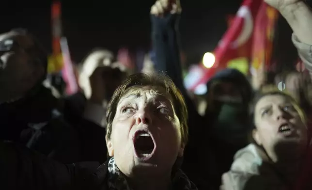 Protesters shout slogans during a protest after Istanbul's Mayor Ekrem Imamoglu was arrested and sent to prison, in Istanbul, Turkey, Tuesday, March 25, 2025. (AP Photo/Francisco Seco)
