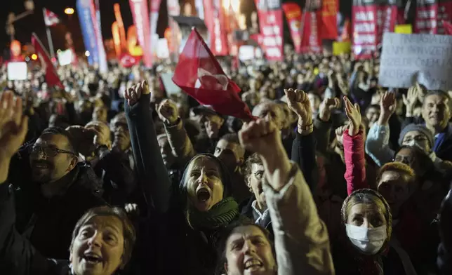 Protesters shout slogans during a protest after Istanbul's Mayor Ekrem Imamoglu was arrested and sent to prison, in Istanbul, Turkey, Tuesday, March 25, 2025. (AP Photo/Francisco Seco)