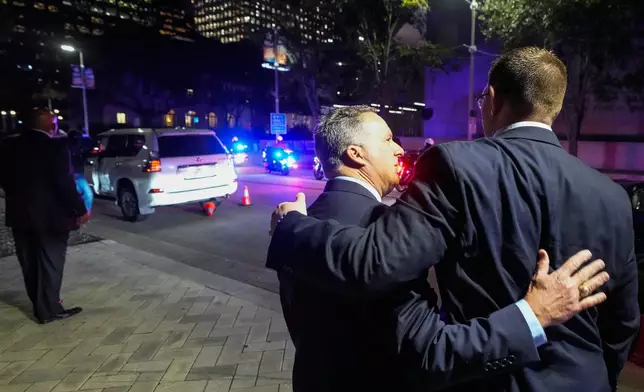Houston Police officer Paul Powel, a member of the mayoral security detail, left, and Jeff Syptek embrace as an honor guard gathers for former Houston Mayor and U.S. Rep. Sylvester Turner to be carried into City Hall where he will lie in state in Houston, Tuesday, March 11, 2025. (Brett Coomer /Houston Chronicle via AP)
