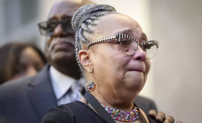 Vanessa Graham-Morgan cries as she waits to pay her respects to former mayor and U.S. Rep. Sylvester Turner as he lies in state at Houston City Hall in Houston, Tuesday, March 11, 2025. (Jon Shapley/Houston Chronicle via AP)