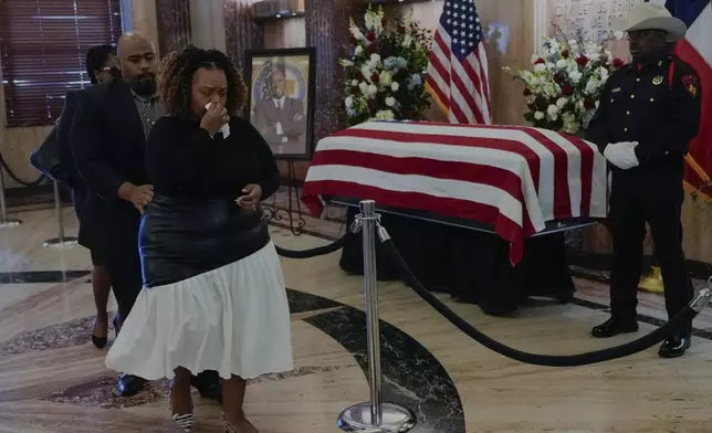 Ashley Turner-Captain and her husband, Jimmy, pay their respects to her father, former mayor and U.S. Rep. Sylvester Turner as he lies in state at City Hall in Houston, Tuesday, March 11, 2025. (Brett Coomer/Houston Chronicle via AP)