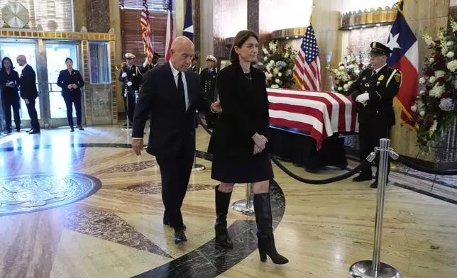 Houston Mayor John Whitmire, center left, and his daughter, Whitney Whitmire, pay their respects as the remains of U.S. Rep. Sylvester Turner of Texas lie in state at Houston City Hall on Tuesday, March 11, 2025, in Houston. (AP Photo/Ashley Landis)