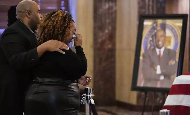 Ashley Turner-Captain, center, views the remains her father, of U.S. Rep. Sylvester Turner of Texas, as he lies in state at Houston City Hall on Tuesday, March 11, 2025, in Houston. At left is her husband, Jimmie Captain. (AP Photo/Ashley Landis)