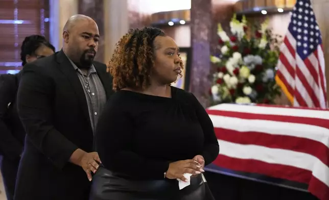 Ashley Turner-Captain, center, views the remains her father, of U.S. Rep. Sylvester Turner of Texas, as he lies in state at Houston City Hall on Tuesday, March 11, 2025, in Houston. At left is her husband, Jimmie Captain. (AP Photo/Ashley Landis)