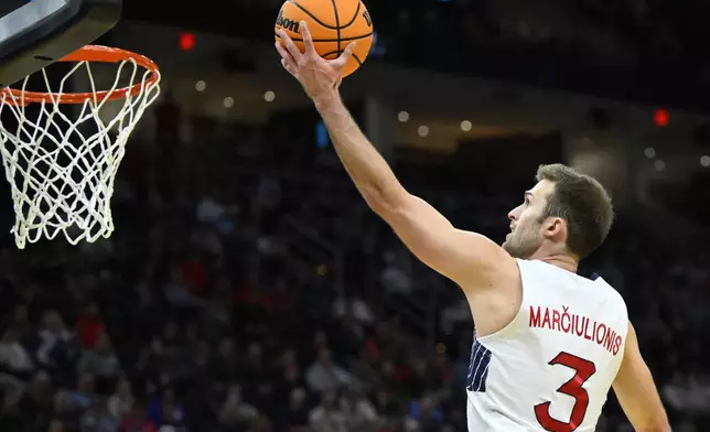 Saint Mary's guard Augustas Marciulionis drives to the basket in the first half against Vanderbilt in the first round of the NCAA college basketball tournament, Friday, March 21, 2025, in Cleveland. (AP Photo/David Richard)