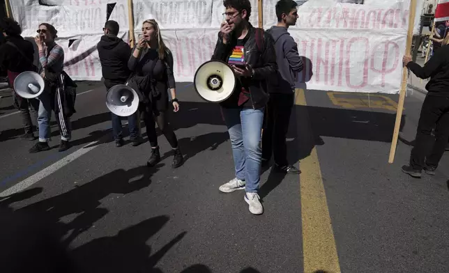 University students shout slogans using loudspeakers during a rally, on the third and final day of a censure motion debate against the conservative government in parliament over a deadly rail disaster nearly two years ago, in Athens, Greece, Friday, March 7, 2025. (AP Photo/Thanassis Stavrakis)