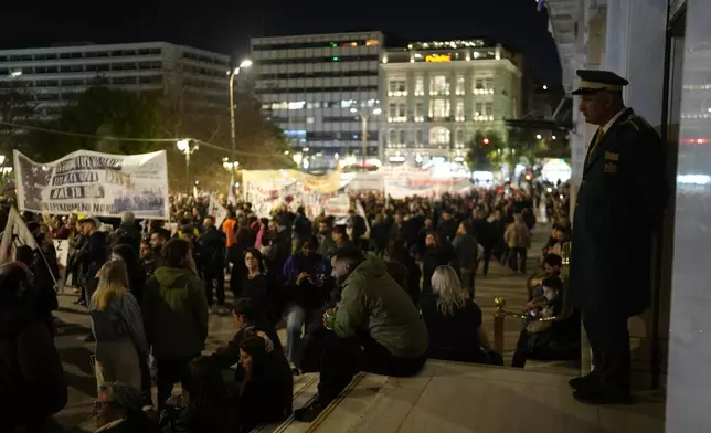 Protesters gather in front of luxury hotels during a rally, on the third and final day of a censure motion debate against the conservative government in parliament over a deadly rail disaster nearly two years ago, in Athens, Greece, Friday, March 7, 2025. (AP Photo/Petros Giannakouris)