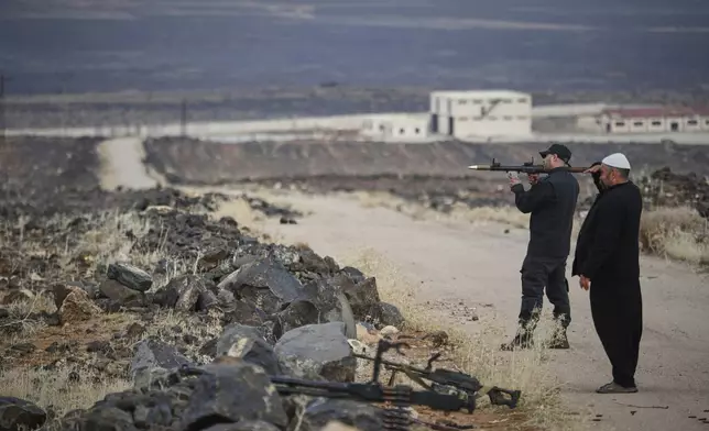 A Druze militiaman holds a small rocket launcher during a shooting practice in the southern province of Sweida, Syria, March 4, 2025. (AP Photo/Omar Sanadiki)