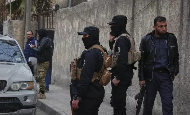 Syrian government security forces stand near a police station in the town of Jaramana, in the southern outskirts of Damascus, Syria, March 3, 2025. (AP Photo/Omar Sanadiki)